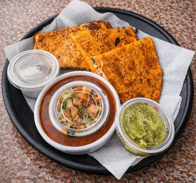 Birria quesadilla with consomé, guacamole and salsa